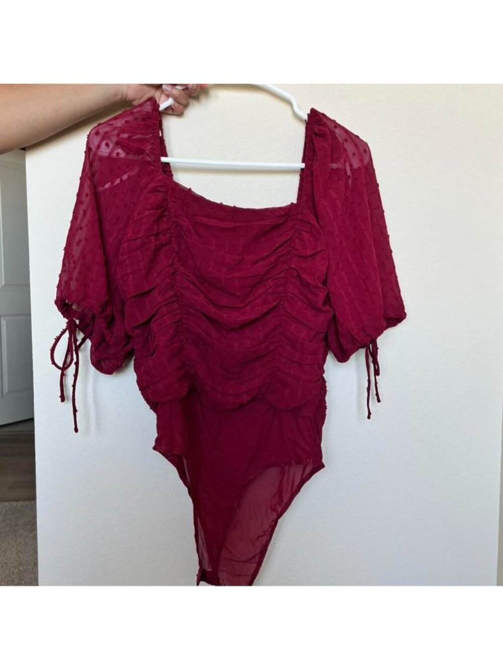Lulus burgundy ruched bodysuit with sheer sleeves and tie detail. Size S